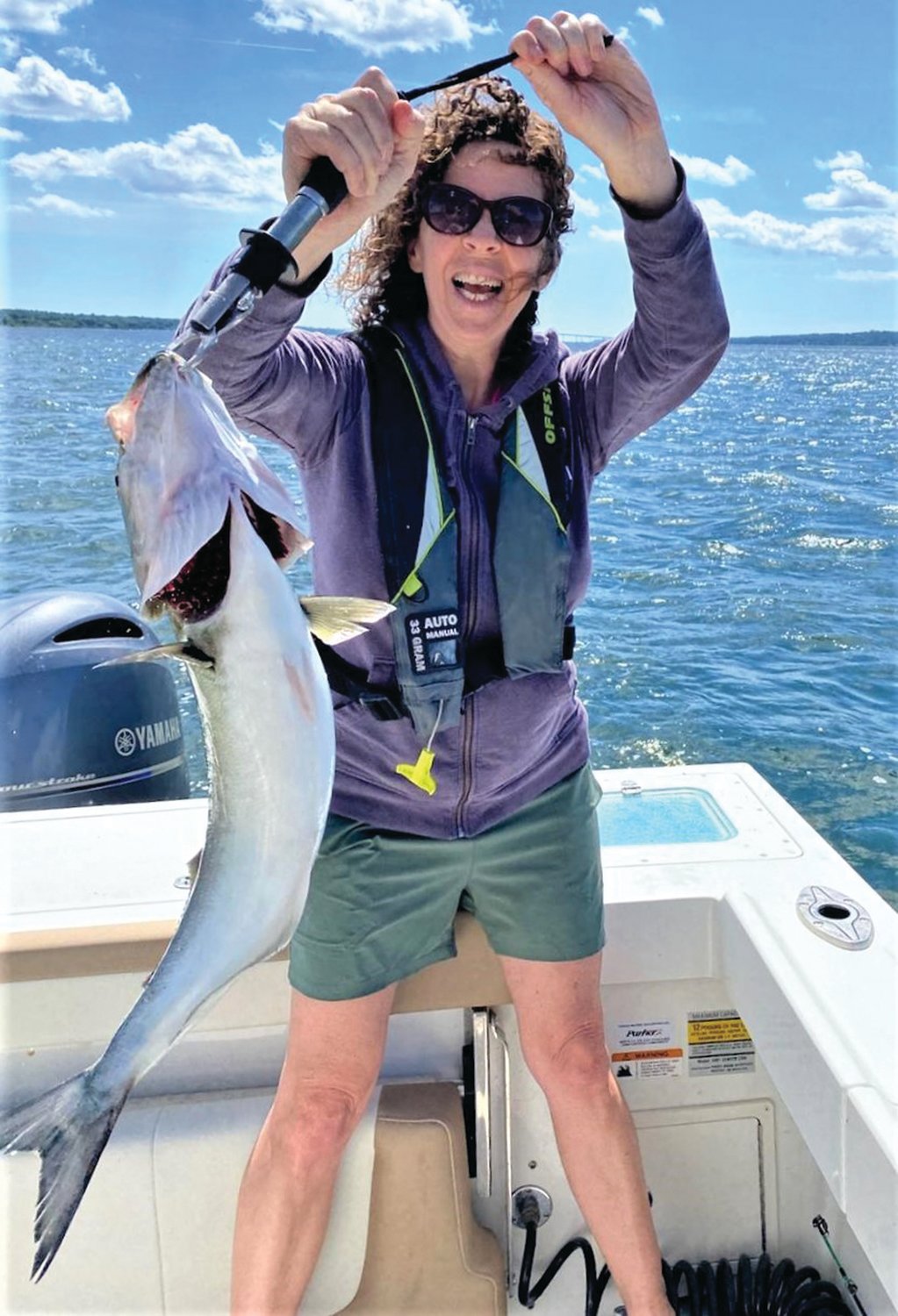 FEISTY BLUEFISH: Amy Moses of Providence with a very large bluefish she reeled in off Quonset Point.